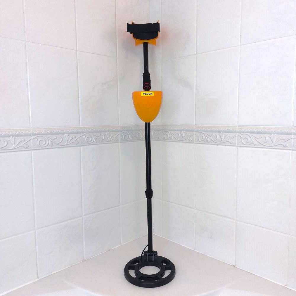 Metal detector against a white tile background