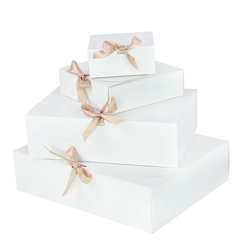Stack of white gift boxes with ribbons on a white background