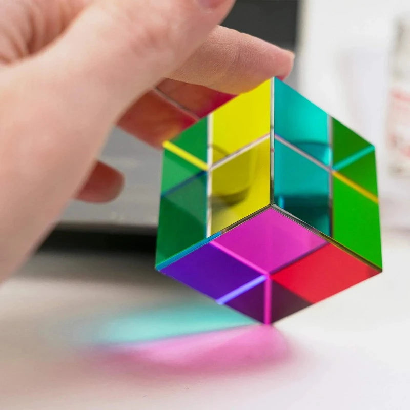 Image from thesciencehut.com: CMY prism cube with light shining through it demonstrating mixing of colours