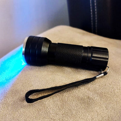LED UV torch side view showing strap