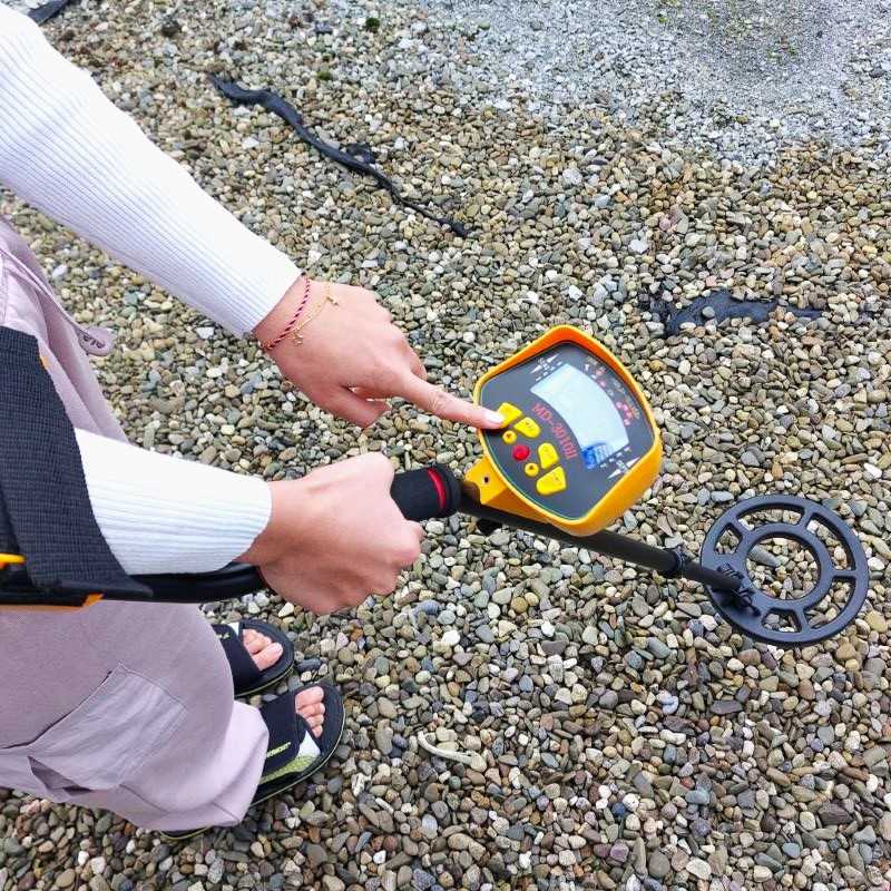 Pressing buttons on metal detector